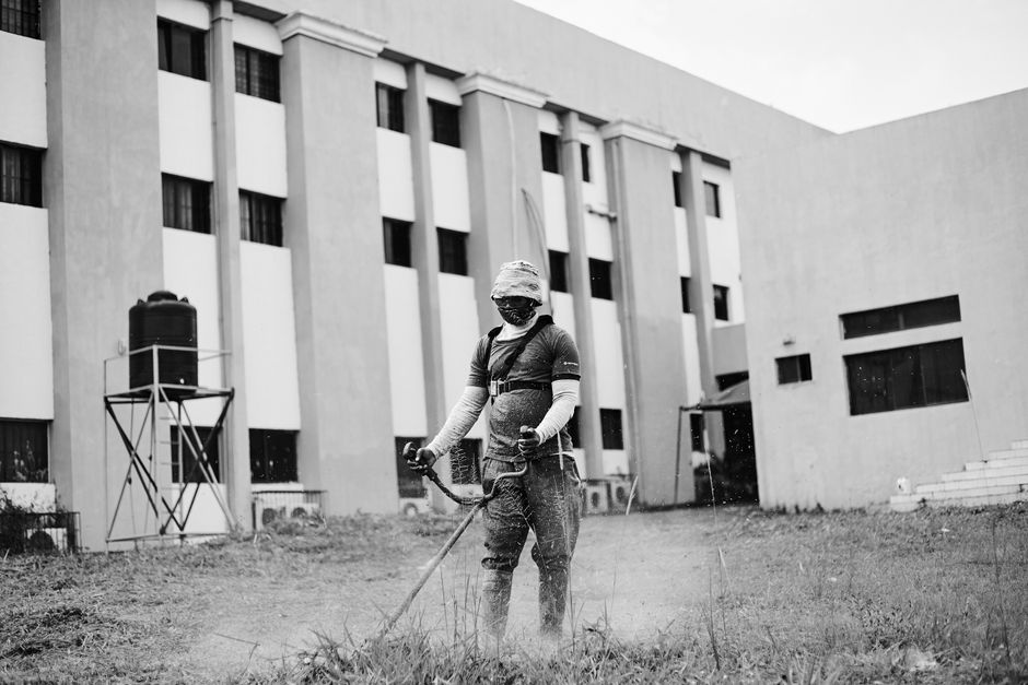 Commercial landscape crew maintaining a business property lawn in New Orleans